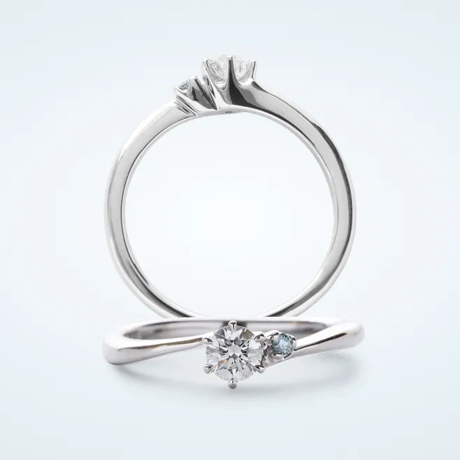 細身のウェーブラインに、センターの 0.2ct 天然ダイヤモンドを 6本爪で留めたリングです。